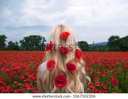 Girl on a poppy field