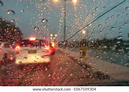 Out Of Focus. Raindrops windshield. Raindrops on the windshield. Blurred image of traffic view through a car windscreen covered in rain.  