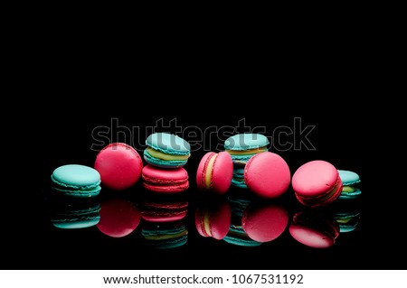 diffrent colorfull macarons on black background .pink color and ment color macaroons Royalty-Free Stock Photo #1067531192