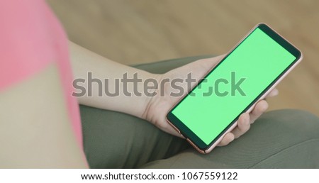 woman use phone and touch green screen