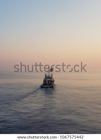 Supply boat under way to production platform Royalty-Free Stock Photo #1067575442