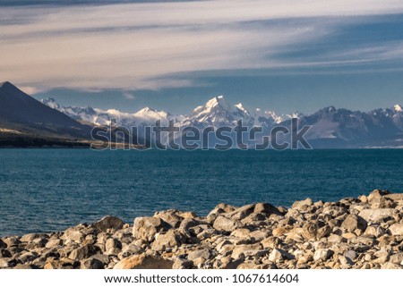 Pukaki glacier lake with turquoise blue water and mountains landscape. Winter mountain landscape with snow and glacier lake. Pukaki lake at Aoraki - Mount Cook National Park, New Zealand.