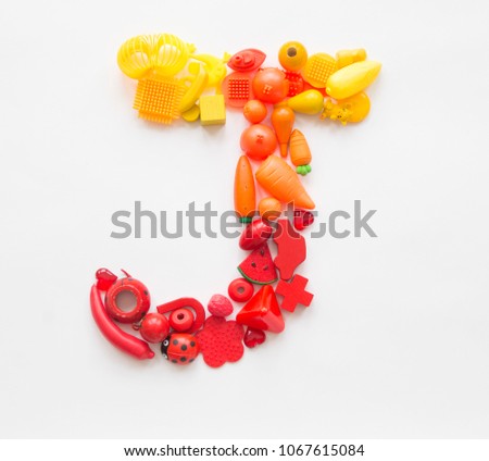 Colorful letter "J" of the toys on a white background. Lots of kids games. Rainbow color Ombre transition.