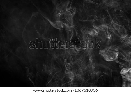 Thick white smoke on a black isolated background. Background from the smoke of vape
Cloud of white smoke on a black isolated background. Background from the smoke of vape
