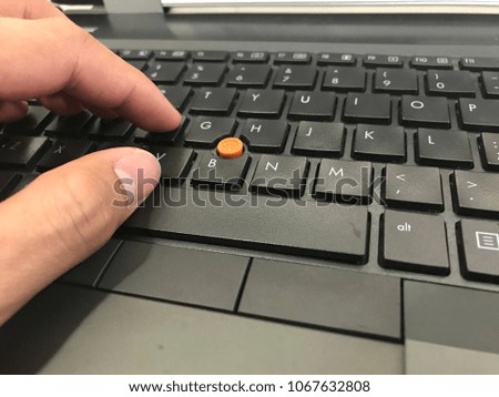 Hand on laptop keyboard