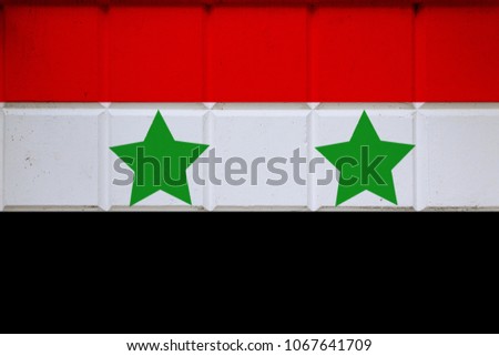 The flag of Syria at the wall.