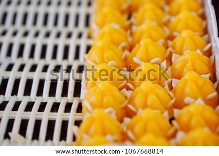 'Jar Mong Kut" Thai dessert : a kind of crown-like yellow sweetmeat mainly made of yolk and sugar.
Mean - as a token of gratitude or an expression of gladness for that person's success