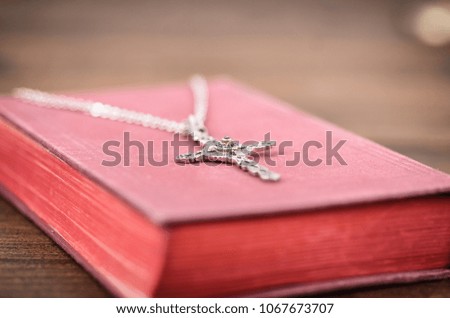 Christian cross necklace on a Holy Bible, Christianity and Religion concept.
