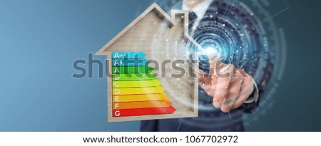 Businessman on blurred background using 3D rendering energy rating chart in a wooden house