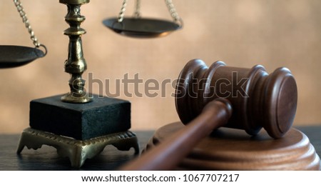 Law symbols on golden bokeh background.
