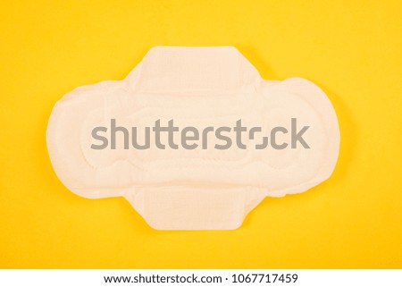 Sanitary pads and tampon on a yellow background. hygiene products.