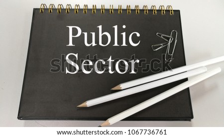 Public sector memo written on a notebook with pencil and paper clip
