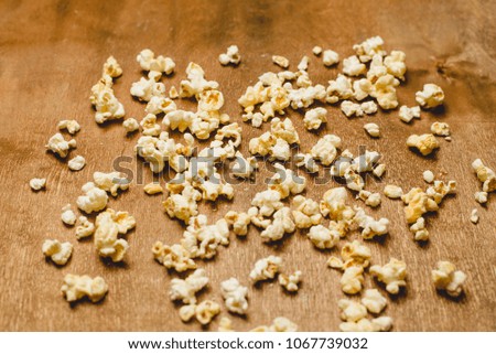 salty Popcorn  on a black wooden background. Films and an elusive concept. copy space