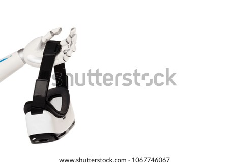 cropped shot of robot holding vr headset isolated on white