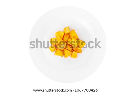 Potatoes diced fried, baked with spices, side dish on a plate on white isolated background view from above. Appetizing dish for the menu restaurant, bar, cafe Royalty-Free Stock Photo #1067780426