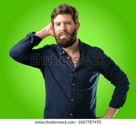 Young hipster man with big beard confident and happy with a big natural smile laughing over green background