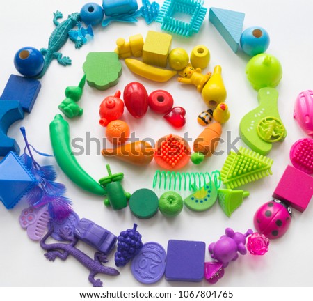 A spiral made of children's toys. Multicolored figures for games. He learns to count in school.