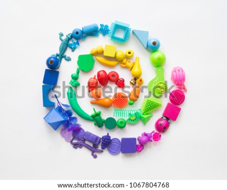 A spiral made of children's toys. Multicolored figures for games. He learns to count in school.