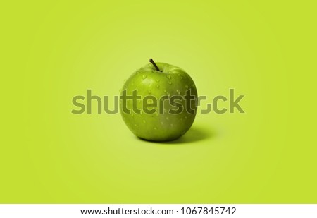 Fresh and wet green apples on the green color background, water drops