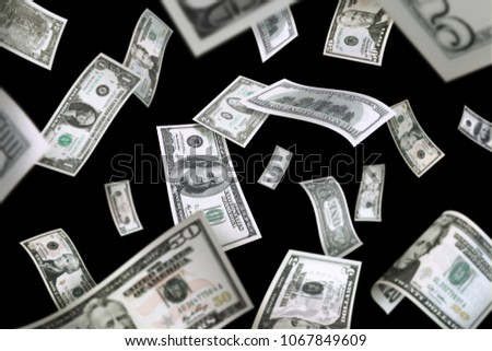 Flying American dollar banknotes, isolated on black background