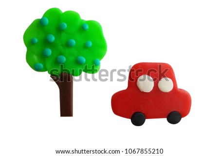 Plasticine cute red car and big green tree isolated on a white background. Clipping path.