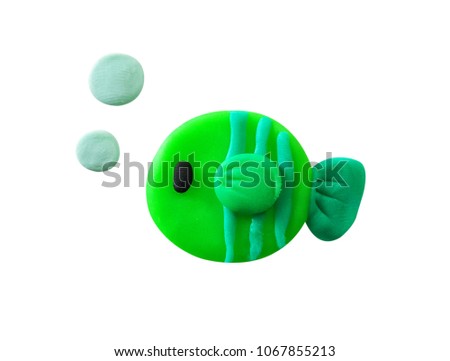 Plasticine cute green sea fish isolated on a white background. Clipping path.