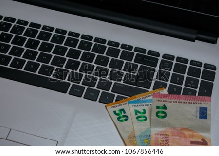 close up on white laptop and euro notes  top view. Business concept  