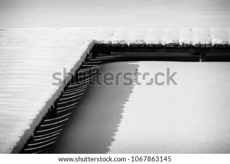 abstract white snow on black dock with stripes