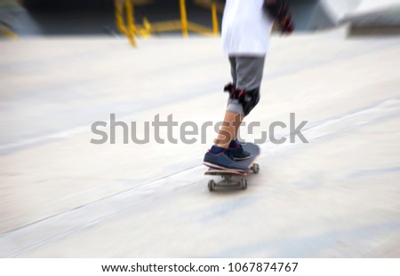 zoom moving shot of sketeboard with child leg for practice on park