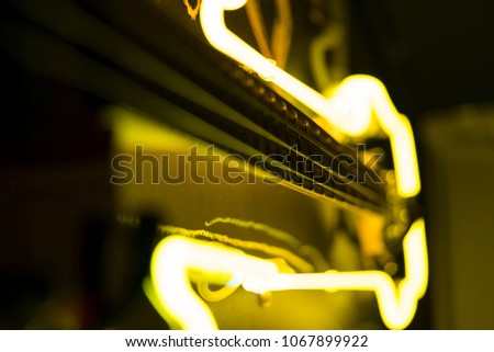 Bass guitar strings closeup, neon light illumination, music wallpaper