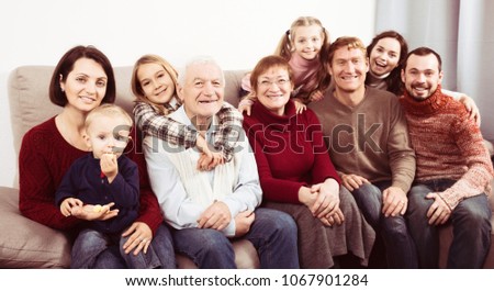 Ordinary family making numerous photos during family dinner. Focus on elderly man