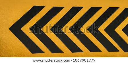 black direction arrows on yellow ground