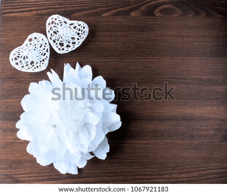 Beautiful wedding background. Snow-white paper decorations on dark wooden background.