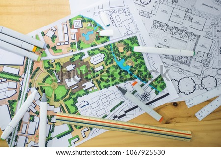 master plan of urban landscape design or urban architecture drawing with drawing tools , color markers, scale rulers on the table, selective focus   Royalty-Free Stock Photo #1067925530