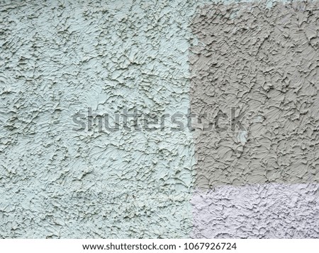 A wall with relief plaster of gray-greenish colors. Abstract background.