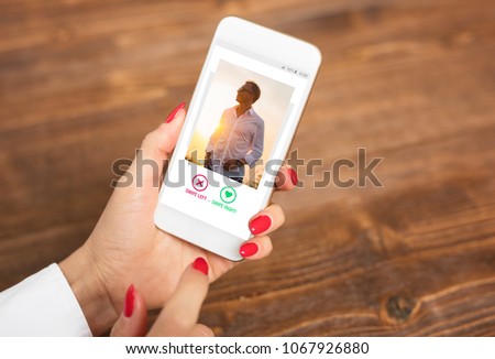 Woman using dating app and swiping user photos Royalty-Free Stock Photo #1067926880