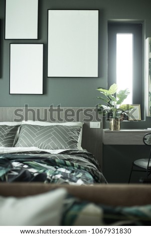 Cozy Bedroom corner with blank picture on the green wall for advertising/Cozy Interior concept