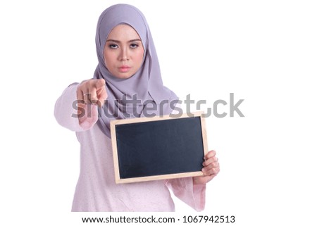 Young Asian woman showing on empty blackboard