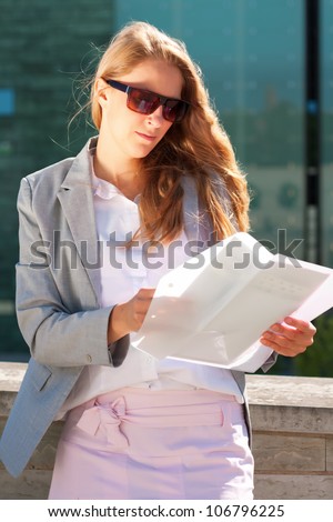Businesswoman exploring documents outside