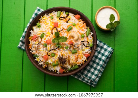 Indian Vegetable Pulav or Biryani made using Basmati Rice, served in terracotta bowl. selective focus
 Royalty-Free Stock Photo #1067975957