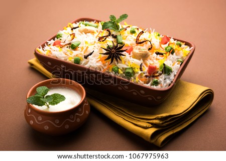 Indian Vegetable Pulav or Biryani made using Basmati Rice, served in terracotta bowl. selective focus
 Royalty-Free Stock Photo #1067975963
