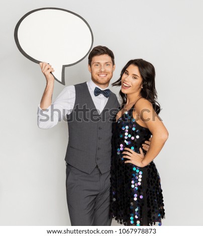 fashion, style and holidays concept - happy couple hugging at party and holding blank text bubble banner