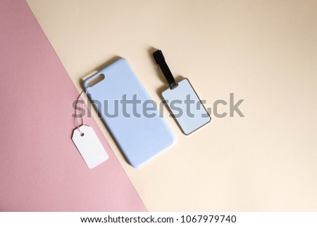 Mock up : Pastel blue color  phone case with price tag and blue name tag or keychain on colorful background