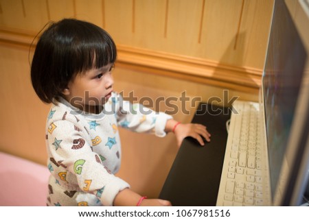 Children watching cartoons on the computer.
