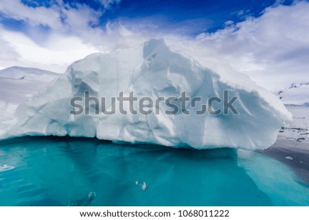 Large, snowy white iceberg floats near Antarctica