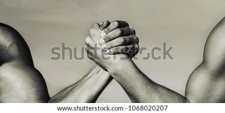 Two men arm wrestling. Arms wrestling, competition. Leadership concept, arm. Two muscular hands. Rivalry concept. Hand, rivalry, vs, challenge, strength comparison. Man hand. Black and white