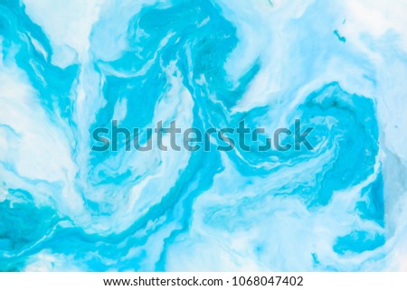 Coloring ink flowing and mixing in milk texture. background image.