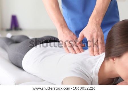 Physiotherapist working with female patient in clinic Royalty-Free Stock Photo #1068052226