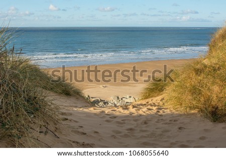 Sand dunes and sandy beach at Woolacombe Sand near Barnstaple in North Devon, England Royalty-Free Stock Photo #1068055640