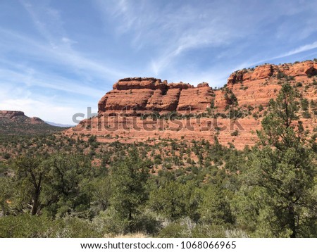 Wispy skies place the grand peaks on center stage. Deadman’s pass may have been a treacherous route long ago but today, it is a wonderful jaunt through some of the best of Sedona's vistas. Royalty-Free Stock Photo #1068066965